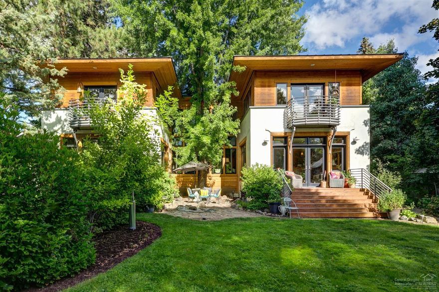 The best things in life are all at your fingertips from this downtown Bend riverfront home built and designed by two artists. Located on the Deschutes River, this perfect oasis offers 130 feet of river frontage with mature landscaping and beautifully designed gardens. The impeccably-designed, 4-bed/3.5-bath home is built around a beautiful tree, and offers plenty of windows and light. The extra large lot also features a detached artist's studio/ bunk house, a bike barn/shed, an attached 2-car garage and a detached garage/shop. This amazing residence in the heart of Bend is a true one of a kind!