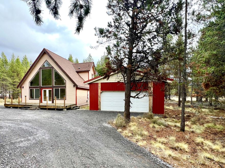 Beautiful 2-bed, 2-bath cabin-style home on over 1½ acres with a 576 sq ft pole barn shop. This home features real wood accents, hardwood and slate floors, all-wood cabinetry throughout. The sunlit vaulted living area with floor-to-ceiling front windows brings in all natural light. A spiral staircase leads to a large loft with recessed lighting, full bath, book alcove and 2 upstairs decks.The kitchen includes a deep quartz sink, all appliances inclu— stove/oven, refrigerator, dishwasher, washer, and dryer — making everyday living effortless. Enjoy year-round comfort with a cozy wood stove and an energy-efficient heat pump. This home awaits your creative touches and care. Set in a quiet, private neighborhood, backs up to 80 acres of National Forest.This location offers endless outdoor adventures that Central Oregon has to offer — as well as peaceful moments of solitude. It's perfect as a vacation retreat or make it your 'Home Sweet Home,' blending comfort and your connection to nature.