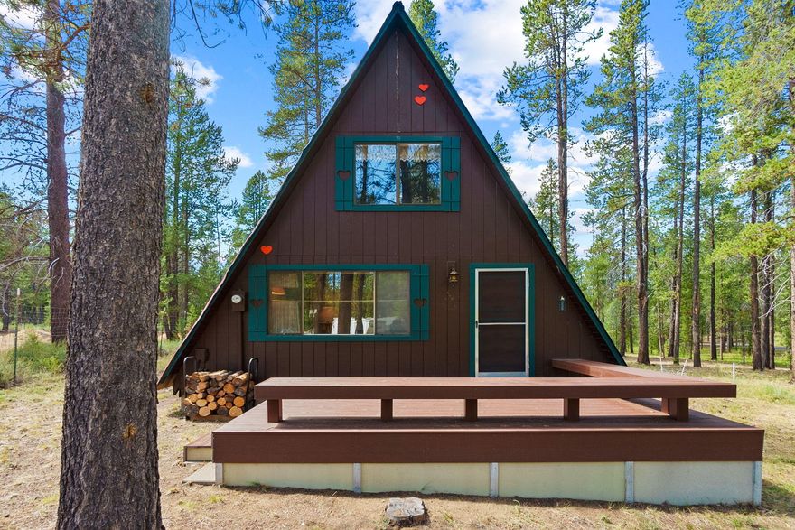 Welcome to your slice of Oregon paradise! This charming A-frame cabin sits on a serene 1.57-acre flat, corner lot surrounded by mature forest. Inside, you'll find 2 bedrooms, 1 bathroom, tongue + groove ceilings + a cozy living space anchored by a wood-burning stove. A spiral staircase leads to the upstairs bedroom, while front + back Trex decks invite you to soak in peaceful forest views + sunsets. Enjoy paved roads, private community river access, newer septic & plenty of room for RVs/toys. The Fall River Hideaway is one of the original homes in Fall River Estates, now comprised of log cabins + large custom homes. Located just 30 minutes from downtown Bend + Mt Bachelor and 2 miles from the Fall River trailhead, you're close to world-class fishing, hiking, + year-round outdoor recreation. Perfect as a vacation home, weekend ski getaway, or full-time residence, this retro-hip home effortlessly blends rustic charm with modern comfort. Enjoy the simple life or build your dream home!