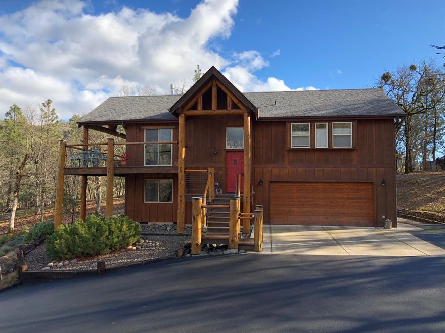 This is a beautiful chalet style, custom built home, located in a wonderful neighborhood, nestled among the oaks. Beautiful woods and log accents welcome you as you enter the home. The great room is a nice open space with a rock hearth, lots of windows and high ceilings. The gas stove will keep you cozy and warm during the winter. The kitchen has nice wood cabinets, a large pantry and a breakfast bar. The master bedroom is spacious and has an attached bath. Downstairs are 2 bedrooms, one is used as an office, a bath and a storage area. You will love the covered, wrap around deck that you can enter from the great room or the dining area. It's a beautiful place to enjoy your morning coffee while taking in the beauty of the surrounding area. The property is nicely landscaped for easy care, and there is a garden shed for extra storage. A seasonal creek runs through this 1.41 acre property and there is room for an RV. This home has been meticulously maintained and shows pride of ownership