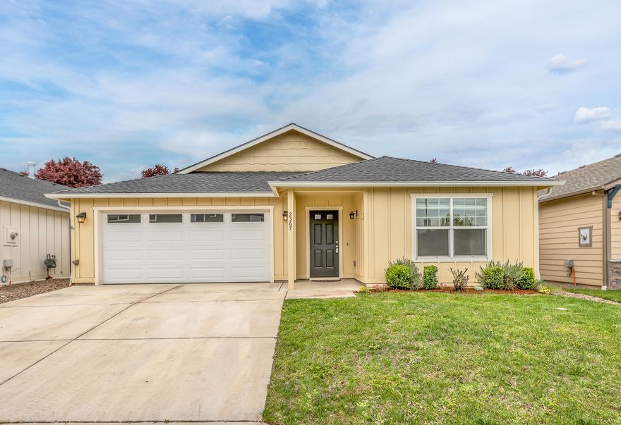 Newer single-level Southwest Medford home with low-maintenance landscaping! Quality features include vinyl plank flooring, vaulted open-concept great room with modern ceiling fan, gas fireplace, sliding glass door to covered concrete patio, kitchen with quartz dining counter, pendant lights, under-mounted farmhouse sink, stainless steel gas range/oven, dishwasher, microwave, and refrigerator. Primary bedroom with two closets, full ensuite bathroom with dual vanity, stone counter, and shower; two guest bedrooms, full guest bathroom with tub/shower,  linen and entry closets, laundry room, and two-car garage. Inquire per offer submission deadline!