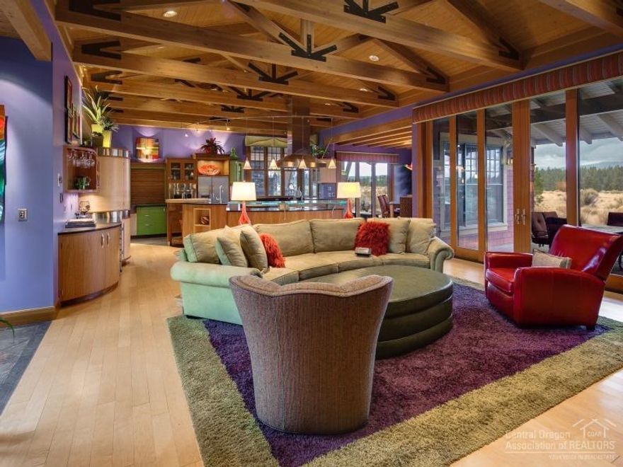 This custom home features 3 bedrooms, 3 full baths, 2 half baths, and unique touches at every turn. Enjoy unobstructed Cascade views from seven rooms. The exterior features three separate outdoor living spaces including an interior courtyard, outdoor kitchen, and 3-car garage. Interior features include exposed Douglas fir beams and ceilings, radiant in-floor heating throughout, and custom built-in woodwork. The home overlooks acres of conservation land abutting Shevlin Park, affording complete privacy.