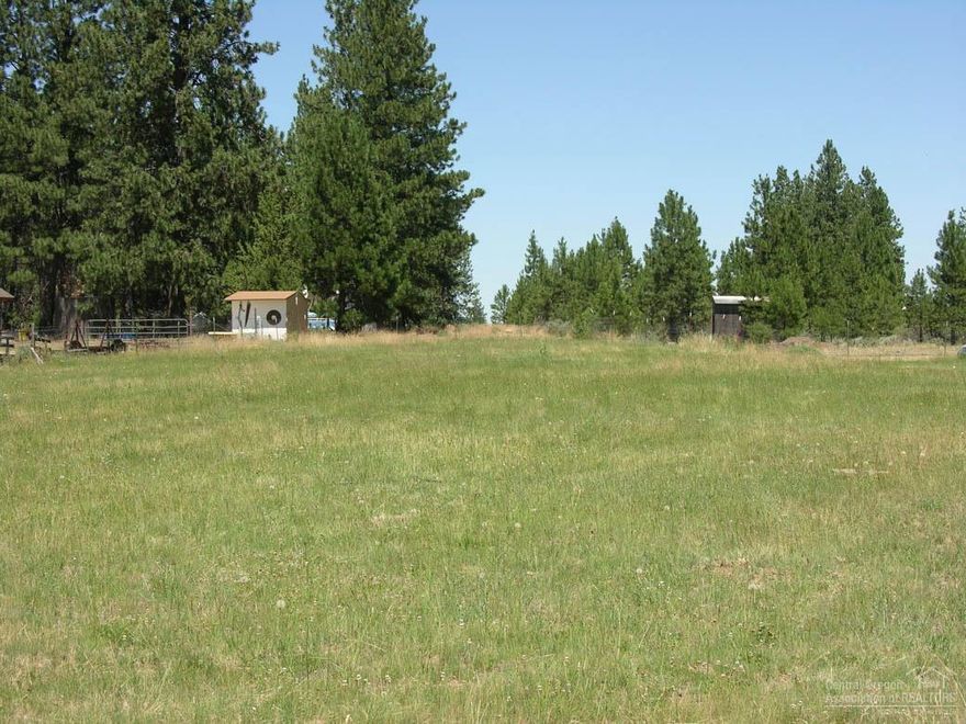 Rare Find in SW Bend's Deschutes River Woods! One of a select few large parcels in DRW with 0.75 acres of Arnold Irrigation water! 1.22 acres backing large private parcels for extreme privacy - power & phone has been trenched and available at the back of the property too! A great home site and horse property with cleared pasture area and back building pad with possible mountain views from a second-story home waiting for you!