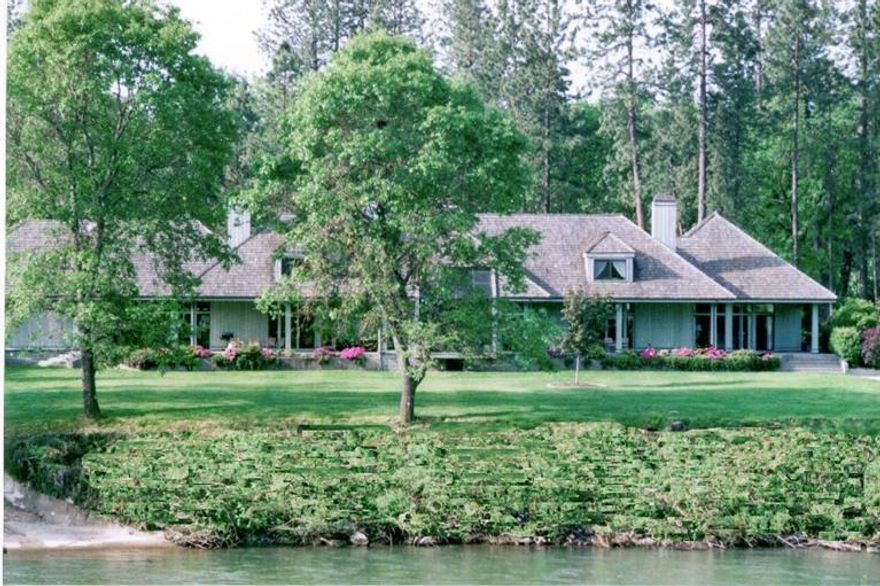 Entering through the wrought iron gate you will come upon an absolutely gorgeous riverfront estate, with mature trees and landscaping. The handsome architecturally designed one-owner home sits on over 3 park-like acres with 272' of Rogue River frontage and views of the river from almost every room. This spacious 6967 square foot home includes 4 bedrooms, 6 bathrooms, an oak pub room, an office/library, 4 fireplaces, great room with floor to ceiling windows, upscale kitchen with island, and spacious main level master bedroom with en suite bath; and an attached 2 car garage . There is also a 2400 sq ft RV garage/shop/office/storage building. A lovely black bottom in-ground pool, pool house with bath and entertainment area. There is a cement boat ramp for easy private river access. A very special place that lends itself to entertaining and family gatherings. At only $1,200,000, it will sell quickly. Call for your personal tour today!