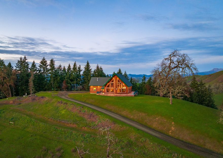 North Umpqua Ranch and Estate - Entering the 160 acre property you are greeted by an immense landscape of rolling green pastures & two distinct knolls that supply unique character. Atop the southern knoll, the Energy Star rated home is situated to take in unparalleled views & is a remarkable place to live - boasting a 30 foot vaulted ceiling & open living space including the dining room & kitchen with wraparound concrete patio that overlook the valley below; two bedrooms, full bath, laundry, & an oversized 2-car garage complete the main floor. The master suite includes a kitchenette, master bath, walk-in closet, private balcony, & even a secret office. A movie theater & large multipurpose room round out the home. The property is fenced & cross fenced providing two main grazing pastures & miles of internal roads, 5 permitted ponds adorn the land & aid the primary use of grazing. Shop infrastructure of +/-10,000 sf is located in the heart of the property with ample space to park equipmen