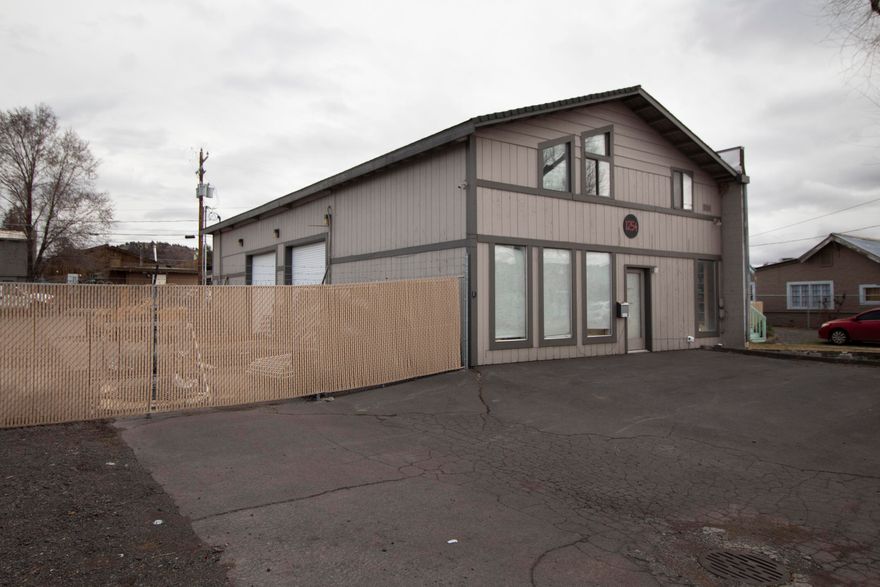 Fantastic flex space centrally located in Bend, zoned CL. This fully fenced property has rollup doors, plenty of parking in the front of the building with additional on-street parking, a showroom area, and a second floor for office and/or storage. The fenced yard is also a separate buildable tax lot. Buyer responsible for due diligence on incentives for this area for redevelopment. Call the listing agent to schedule an appointment for showings.
