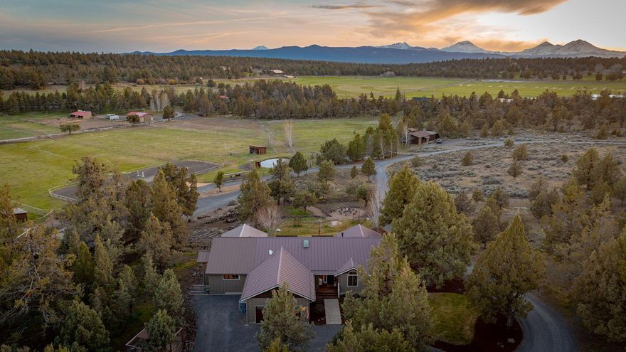 A picturesque blend of country living & equestrian luxury, this roughly 10-acre parcel w/ 6 acres of Tumalo irrigation with an underground irrigation system. Cascade Mountain views, privacy &  functionality for horse enthusiasts or hobby farmers. The single-level residence w/ 4 bedrooms features hardwood floors throughout, 2018 primary suite addition w/ radiant floor heating in the bathroom & walnut cabinetry. Step outside & experience the lifestyle this land was made for. Watch horses or other farm animals graze from your deck on one of the many fenced pastures, gather around the fire pit under the stars, or ride in the outdoor arena. The barn features 4 stalls w/ runs, automatic Nelson waterers, a groom stall & freshly updated heated tack room w/ a full bath, perfect for seamless care & comfort. A new custom chicken coop adds charm & functionality, making this property ready for your next chapter!
