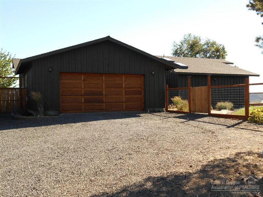 3.9 acres above the city of Prineville. Enjoy spectacular views of the Cascades, Ochoco's and Prineville Valley. The main home has 2 large bedrooms, 2 baths, remodeled kitchen, sun room, hard wood and tile floors. Enjoy lot's of natural lighting from an abundance of windows and skylights. Good sized barn was converted to shop and office space with guest suite above.