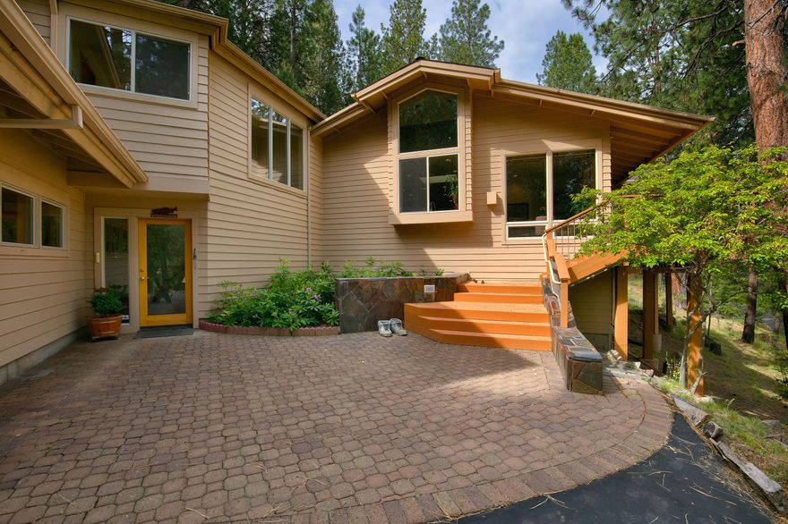 Set on the bank of the breathtaking Deschutes River, this one of a kind 3,223 sqft home is waiting for your personal touch. You won't want to miss an opportunity to own just over 3 acres of highly sought after riverfront property in the private gated community of  River Bluff Estates just minutes from all Bend has to offer. Tucked in mature pines and meticulously maintained landscaping, the layout of this home maximizes stunning views from every room. Upon entering you are greeted by a lodge style Great Room with an expansive stone wall fireplace and floor to vaulted ceiling windows overlooking the peaceful river drifting by. Entertainment bar boasts incredible copper detailed countertops and an exclusive commissioned wood carved support post. The river views continue over to the gourmet kitchen with large u-shaped kitchen island to maximize seating and counter top space. Main level master bedroom opens to large wrap around patio to listen to the passing water as you drift off to sleep