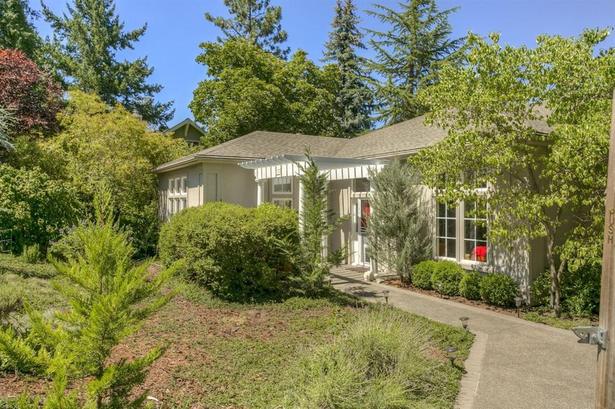 Gracious home very close to town, just above the library. Large spacious rooms with 10' high ceilings, very open with lots of light and mountain views. Main level living with 2 master bedroom suites, large walk in closet, spa-like bathroom, warm double fireplace, French doors to a large veranda for outdoor living/dining with Hot Tub & gorgeous views. Wood and slate floors. Downstairs has a third bedroom with exterior entrance & full bath, a large bonus room, tons of storage, and a 3 car garage - one bay for an RV. New HVAC system. It also has a charming 900 sq.ft. 2/1 guest/rental house, (R-2 zoning may allow for travellers accommodation, also possible lot split - buyer to check with City) currently rented, under market value, month to month @$1000. Guest house square footage not included in the 3220 of the main house. Easy care yard, inground sprinklers, no mowing, with beautiful trees and rose garden. Some of the furniture may be purchased. It's a lovely home in a wonderful