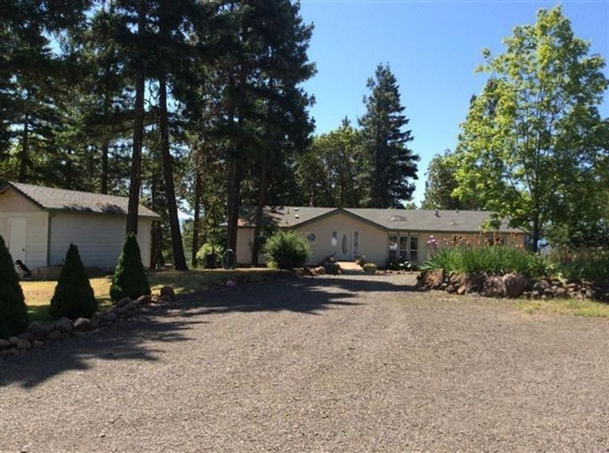 Imagine stepping out your front door standing on your own 20 acres w/ incredible views & best of all never owing a utility bill because this property is off the grid, self-sufficient. The property has mixed timber including pine, fir, cedar, oak & spectacular madrone trees, good wildlife habitat & easy access to BLM. The home is located on a cleared hill top w/ a park-like setting. The owners developed this property for their full time residence which meant a custom manufactured home w/many upgrades, such as Hardy Plank siding, master suite, plus 2 mini-suites, bay windows, solar tubes & sky lights. Keep warm all winter by heating w/ wood from your property in the airtight fireplace insert. Nice country kitchen w/ room for a table to enjoy meals. Oversized 30X40 garage w/ dbl & single bays & shop area. Well house has 2000 gallon holding tank w/ a pressure tank & rm for storage. Power building houses impressive fully automatic system run off solar, diesel generator, & batteries.