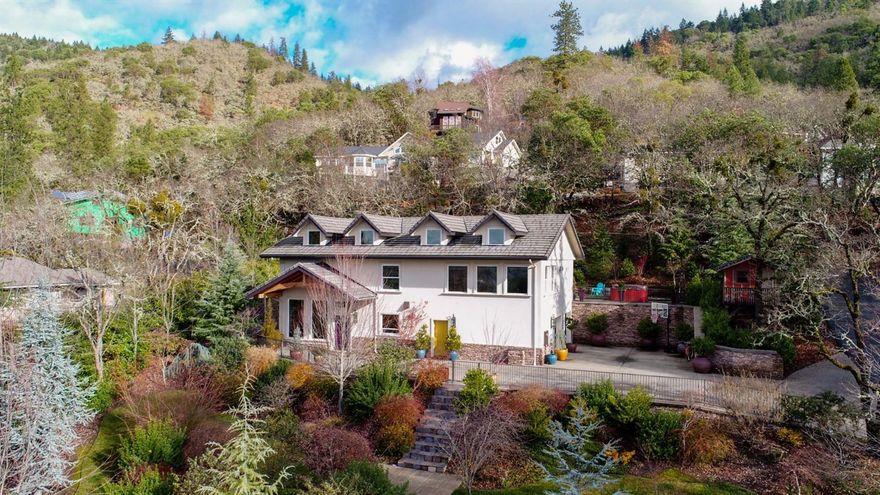 Top quality European style home with beautiful views is super energy efficient with 18 conc and steel walls covered by 30 yr synth stucco, topped with lifetime tile roof. The inside features granite counter tops and slate floors, solid black walnut cabinetry, Wolf Range, Subzero refrig, fully wired media room/office, 2 fireplaces and laundry room with chute. Radiant floors in the entire downstairs, 3 bedrooms, 3 full baths, 600 sf master ste with f/p & slate & glass block shower. 2 car attached garage/workshop, beautiful landscaping and private patio in back with sink, counter & cabinets. Great location close to town, shopping & schools.