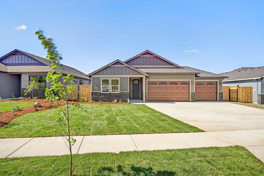 Stunning new home with upgrades throughout! Features a spacious 3-car garage with 8' insulated doors & quiet side-mount motors. Enjoy 9' ceilings, vaulted living room, engineered hardwood flooring, and split floor plan. The gourmet kitchen boasts quartz countertops, gold-accented GE Cafe appliance package (inc fridge), soft-close cabinets, under-cabinet lighting, a pot filler, and cast iron Kohler farm sink. The luxurious primary suite includes coffered ceiling with fan, dual walk-in closets, double sinks, walk-in quartz surround with glass doors. Tile floors in laundry and bathrooms. Tech-forward with EV-ready panel, Ring doorbell, Ecobee smart thermostat with full WiFi/smart home compatibility. Relax on the covered back porch overlooking a fully landscaped yard with sprinklers and drip system. Extras include an electric fireplace, solid interior doors, full wood-wrapped windows, and extended driveway. A must-see blend of style, comfort, and efficiency! Agent related to seller.