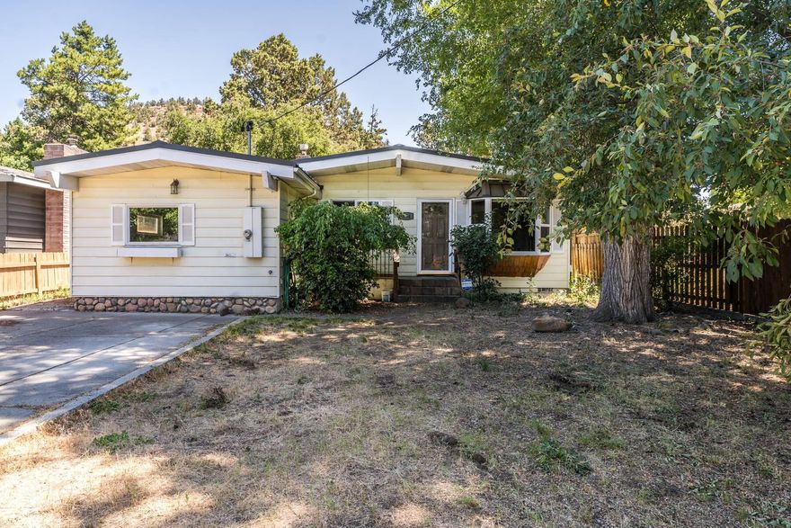 Charming and super clean 3 bed, 1.5 bath home in Bend's sought-after Orchard District! Nestled in a quiet midtown neighborhood near parks, schools, shopping, and the Larkspur Community Center, this home is ideal for first-time buyers or investors. Interior highlights include original hardwood floors, French doors to the backyard, cozy tile fireplace, newer gas water heater, and beautifully updated bathrooms with new bathtub, surround, fixtures, and vanities. The garage conversion adds 308 sq. ft. of bonus space (not included in total sq. ft.)—perfect for an office, gym, or hobby room. Enjoy 4th of July fireworks from your own yard or relax on the spacious back patio. The backyard also features a small shed and plenty of room to entertain. A well-maintained gem in a prime location!