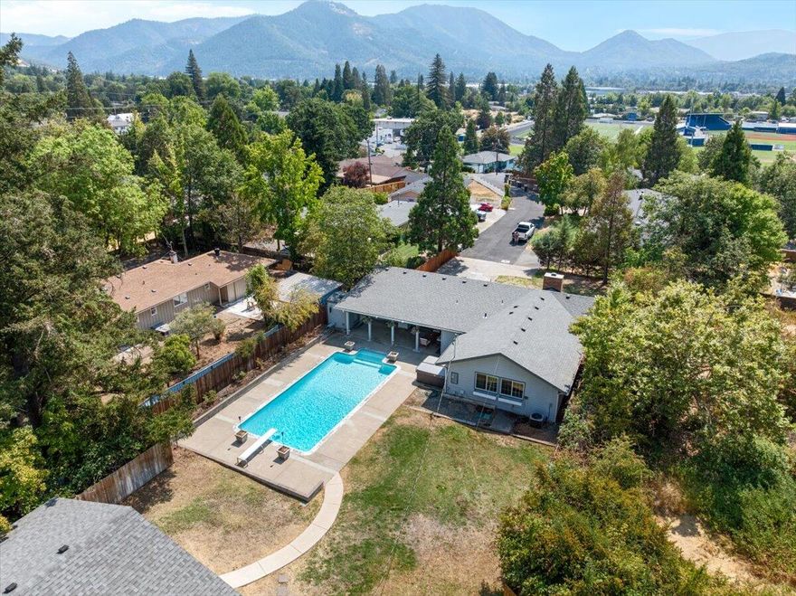 Nestled on over half an acre, this beautifully maintained home offers the perfect blend of comfort and space. Step inside to vaulted ceilings and an updated kitchen that's ideal for both everyday living and entertaining. The open layout flows seamlessly into the fully improved backyard featuring a pool, relaxing hot tub, and a fully fenced & gated yard. 

Need room for hobbies, toys, or a workshop? The detached garage provides all the space you need and more. Whether you're seeking serenity or the ultimate setup for entertaining, this property checks every box.