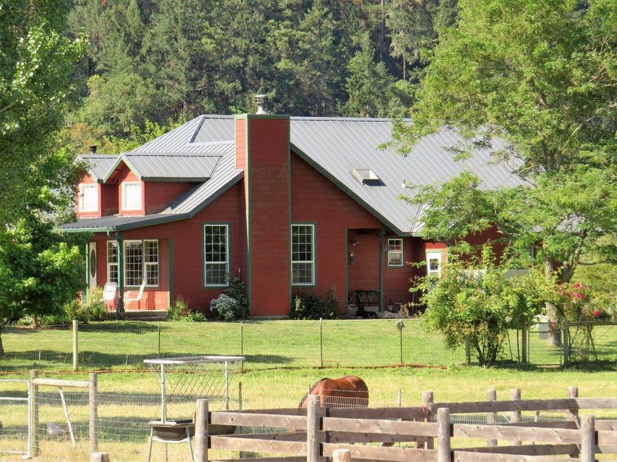 Fantastic Applegate River Ranch! End of the road, river front, irrigation rights, EFU zoning, and a beautiful setting. This property is located just past Cantrall Buckley Park and has great river access. 58.84 acres in pasture and trees. 33 are irrigated out of the Applegate River and is on demand. Irrigation equipment is included in this sale. Great single level home with a large open living room. Barn with covered run-ins, large round pen and several pastures for turn out. Dry cabin in the mature cedar grove. Home was built in 1940 but had a complete remodel in 2001. Large levee around property along the river for protection and the homeowner has an elevation certificate for the home. Several outbuildings for all of your ranch needs, tack room, chicken coop, wood shed and store room.