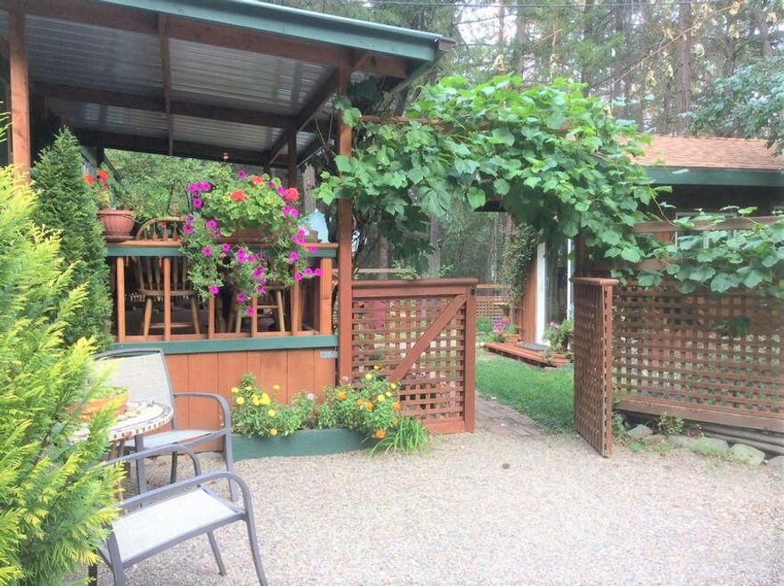 Picture Perfect, Country Get-away with Applegate river access! 2 bedroom, 2 bath, adorable 1977 Mobile on approx. 2 acres. Home has been updated and is charming. Beautifully landscaped with outdoor shower, bath house & outbuildings for your personal, outdoor mini-spa.  The detached studio has a cedar ceiling and bamboo floors, large sliding glass door, and picture windows. Large deer fenced garden area with greenhouse. The property has access to the Applegate River and is completely furnished - turnkey to move in ready. This is a must see to appreciate. 70 gpm well when drilled. This is a perfect home or getaway!