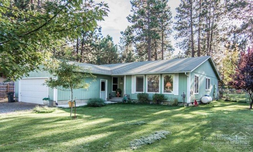 Peaceful setting on a half acre+ w/big trees and lovely landscaping! Wonderful, sunny single level home is neat & tidy w/a great floorplan and spacious rooms. You'll love the gorgeous master suite w/beamed ceiling, a huge walk-in closet, Bay window overlooking the back yard & lovely, updated master bath w/double sinks. The covered patio creates perfect outdoor living space with a water feature nearby. Lots of great plantings plus a greenhouse! Home has a large fenced yard and RV parking. Backs to canal.