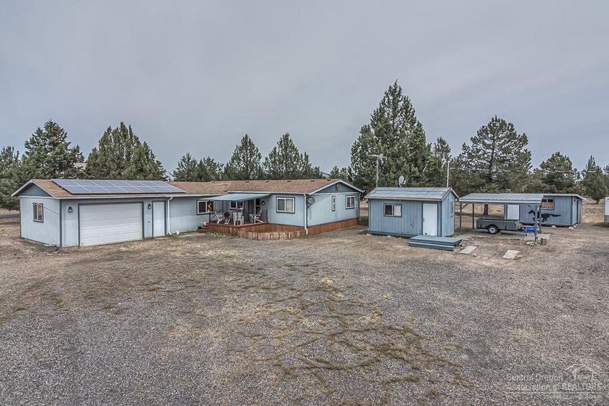 Well maintained 1,652 sq ft manufactured home. It features an attached oversized 2 car garage, 3 bedrooms, 2 bathrooms, bonus room, laundry room, covered front porch, large back deck, 2 RV pads with full hook ups, & multiple outbuildings & sheds to store all your toys & equipment.