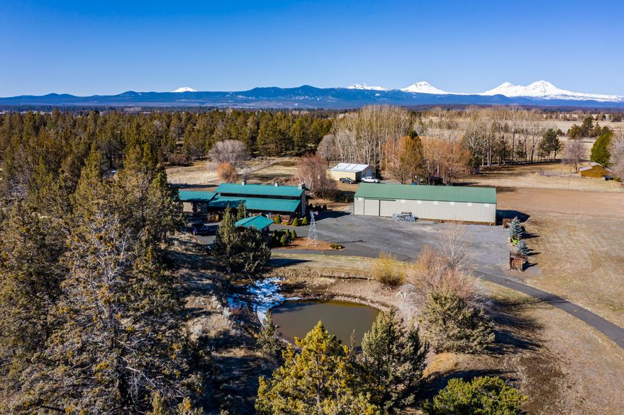 Great opportunity to purchase two separate tax lots in one! 64979 HWY 20 is 10.3 acres and 64975 HWY 20 is 4.6 acres for total of nearly 15 acres. Located just outside of Tumalo and minutes from Bend, this MUA10 zoning creates a vast amount of opportunities. Complete with 7 acres of Tumalo Irrigation water rights, Cascade mountain views, massive 5250 SF shop plus a large detached finished and heated 3-car garage. The ranch style 3,530 SF home offers an open floor plan, large vaulted ceilings with a gorgeous floor-to-ceiling stone fireplace. The master bedroom loft includes 3 closets and soaking tub. The main level floor plan features large great room, kitchen, second bedroom, 2 additional full baths plus bonus room and office that could easily become third or fourth bedroom. Two wells, shared well & private well. This property is a special one-of-a-kind opportunity in Central Oregon.
