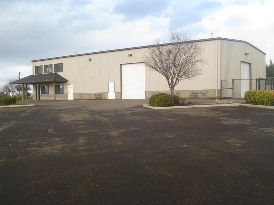 Immaculate warehouse with executive office suite, sales offices, and retail showroom with reception. The insulated, heated warehouse consists of 3,216 sf with 2 OH 14' doors and shop bathroom. A 12,000 sf gated, fenced storage area is adjacent. Paved and lighted, the 2.25 front acres allow for large outdoor display space and exterior signage visible from both directions. An add'l 1.91 acres partially fenced, behind the bldg provides room for expansion, storage, or possible build-to-suit (price neg.). The 2,437 sf main level is office, retail, reception, showroom, and ADA bathroom. The upstairs view suite and conf. room or 736 sf apartment is furnished with hardwood floors, dishwasher, stovetop, microwave, refrig hookup, granite counters, extensive cabinets, and full bath with tub, shower, and sink/vanity. Two add'l offices complete the upstairs. Premium location for traffic count, visibility and signage, across from Lowe's/Walmart/Hobby Lobby shopping complex and Les Schwab Tires.