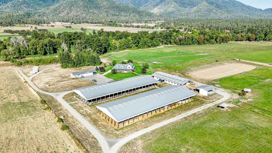 Williams Creek Ranch - a premier income-producing equestrian estate in the heart of Southern Oregon's Williams Valley. This turnkey horse training and boarding operation offers over 50,000 sq.ft. of covered equestrian facilities, including a professional indoor riding arena, training barn, stall barn, and shop, as well as an outdoor dressage court and round pen ideal for clinics, events, and long-term boarding income. The property features 1,200 feet of year-round creek frontage, multiple irrigated pastures, fenced paddocks, and scenic riding trails for various experience levels. The 3,900± sq.ft. custom farmhouse  blends rustic elegance with modern design, while a second dwelling unit provides excellent rental or staff housing potential. Surrounded by panoramic mountain and valley views, this remarkable property combines lifestyle, location, and strong commercial potential, offering one of the region's finest opportunities to own a fully equipped, income-generating equestrian ranch.