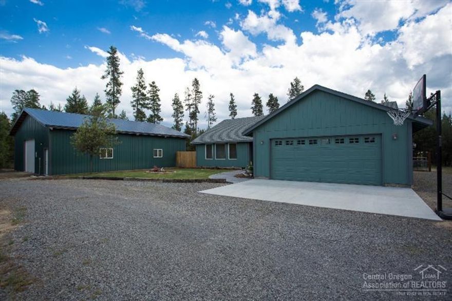 WOW...this truly is turnkey ready! Freshly painted inside & out, landscaped, partially fenced, circle driveway, private from the street, close to a paved road. 1900+SF 4/2, lg. kitchen pantry...cooks dream! Granite counter in kitchen with SS appliances included. Lg. living rm, vaulted ceiling, electric fireplace. Also included in the sale; Pool Table, stop light, pellet stove, pergola, snow blower. Shop is 36' x 48'. Outdoor BBQ area, tool shed, fire pit. Come check it out!