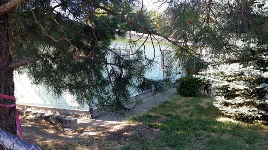 This home is bright and shiny, newly painted inside and new laminate flooring throughout. 3 bdrm 2 ba on a corner lot fully fenced with a detached 2 car garage. Split floor plan, sunken master tub, skylight in the kitchen, walk-in pantry.