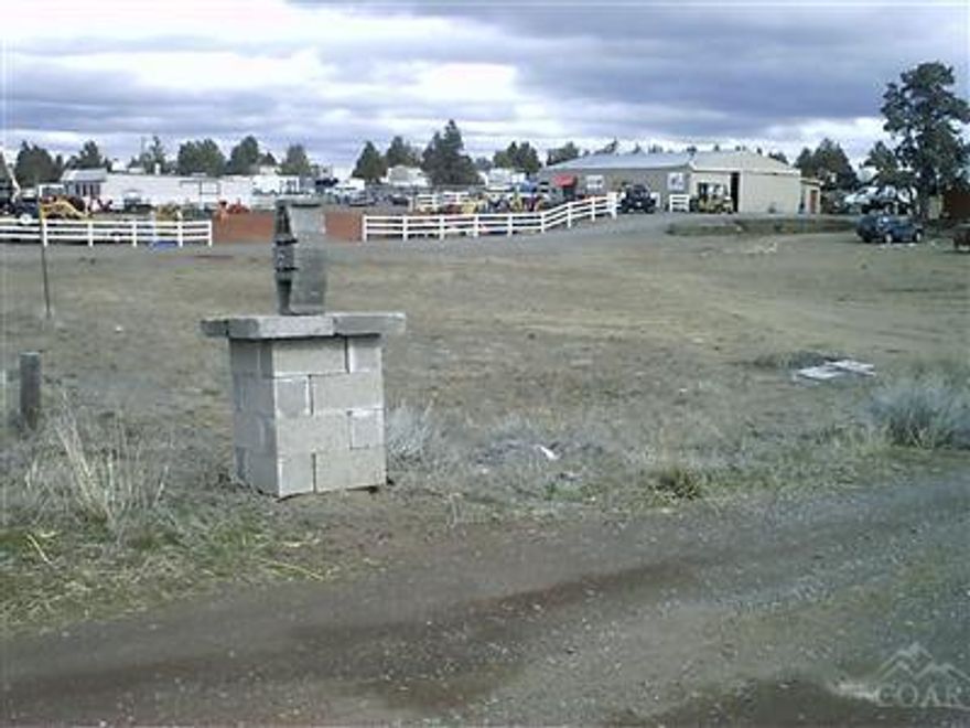 Hwy 97 Frontage Acreage (2.94 acres +/-). Great visibility for business, subject to zoning restrictions. Home site already established with utilities in place. The mobile home and other buildings will be removed upon sale of land.The pump house stays.