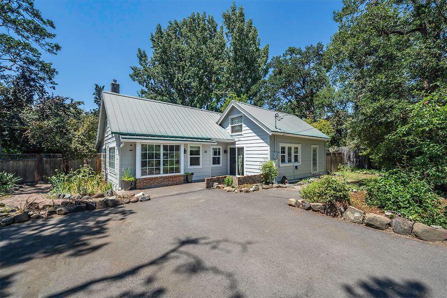 Built in 1934, ''Café Renault'' is rich with historical charm. The name was coined from a plaque discovered when re-siding the exterior. Rumor is this was the builder of Central Park Addition's personal home and believed to be Harry and David's residence at some point. Tucked into a quiet street just outside city limits, this home is conveniently located between Medford and Jacksonville. Unique architectural details throughout the home including exposed beams, tongue and groove cedar walls, and custom woodwork on the stairs. A spa-like bathroom downstairs has been tastefully updated with standalone bathtub, shower, and sauna. You will never want to leave the backyard. A large arbor-covered deck looks out to the garden, pond, and chicken coop. A finished guest house in the backyard provides bonus space or a home office.