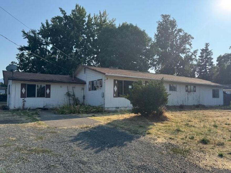 This gem offers bounds of potential. Located on a huge corner lot.   Located close to schools and shopping. This property has tons of room for parking with access from 2 streets and has a large covered deck in back. Step inside this large sq ft home that offers a bright living room, large bonus room and so much more. Come check out the immense possibilities!