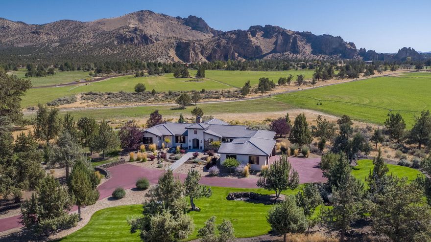 Rare and affordable opportunity to own a beautiful home on a pristine 7.14 acre home site in Ranch at the Canyons! The privacy and beauty of Ranch at the Canyons is an unmatched gem in Central Oregon, and is located at the base of Smith Rock state park, giving you access to miles of trails, river access, rock climbing, equestrian facilities and ponds. This exquisite single level home boasts epic Smith Rock views and features a great room floorplan, gas fireplace with stone mantle, vaulted ceilings, exposed vintage wood beams, hardwood floors, custom tile arched hallways and iPad controlled smart lighting system. The kitchen features a stone slab island with 9 soft close drawers and seating area, 6 burner gas range, griddle, double oven with SS hood and a built in refrigerator/freezer. Additional features include 3 car garage, 2 water features, large outdoor patio living space and the home is wired with 1 gig fiber optic high speed internet making it the perfect work from home getaway.