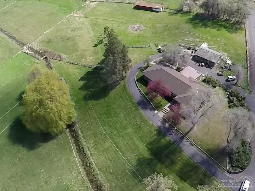 Amazing home, lush setting, beautiful finishes and character! 5 bedrooms/3 baths, great layout w/formal dining room, laundry/mud room, lots of storage, fully finished basement w/bedrm, bath, family room and plumbed for a wet bar. Fully refreshed home includes the following updates: electrical, plumbing, stucco, exterior and interior paint, flooring, counter tops and more! Grounds include wrap-around drive, patio, detached garage, cross fenced pasture w/McKay Creek running through it and a barn.