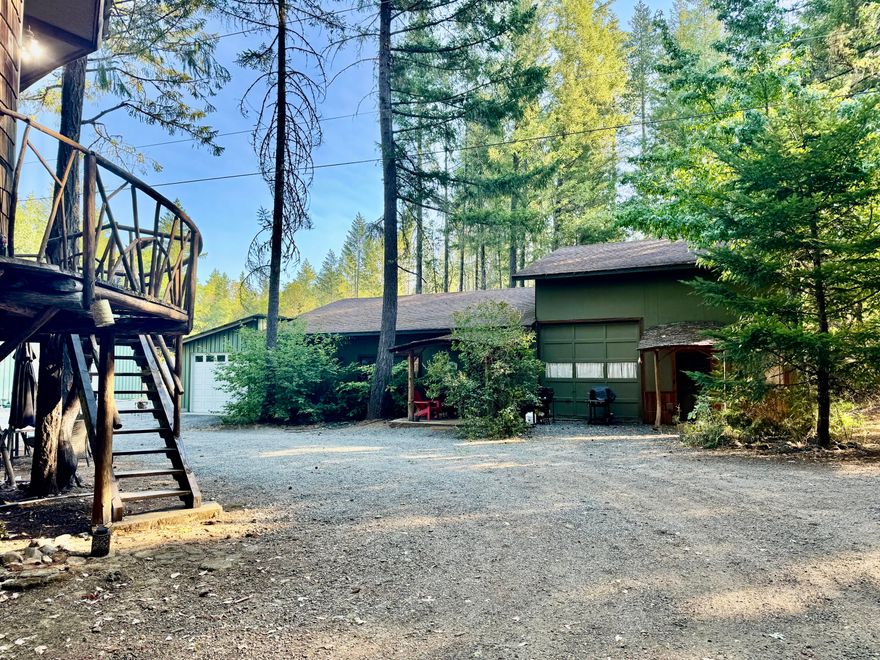 This home is a MUST See!  Sitting on beautiful 15 acres adjacent to the Illinois River with private river access and backing up to BLM Land for privacy.  This unique 2,600 sq ft home features a wide open floor plan, high ceilings, primary down stairs, cord wood art log wall, cement floors, and a roll up door allowing for easy access the outdoors nature or for a vehicle access to the main living room.  The property features a one of a kind 200 sq ft guest treehouse with private bath and toilet.  A huge bonus is the  40 X 60 shop with 5 rooms, loft and 400 amp panel inside....a man's dream!  The property also comes with 2 green houses, a irrigated gardening area and 3 shipping containers - 2 are connected by a mini shop in between.  Lots of privacy with a gated entrance.  There is a 3500 sq ft log Cabin next to this house (great for multifamily living)  that can be purchased together with this home for additional price.....can be negotiated....Bring all offers!