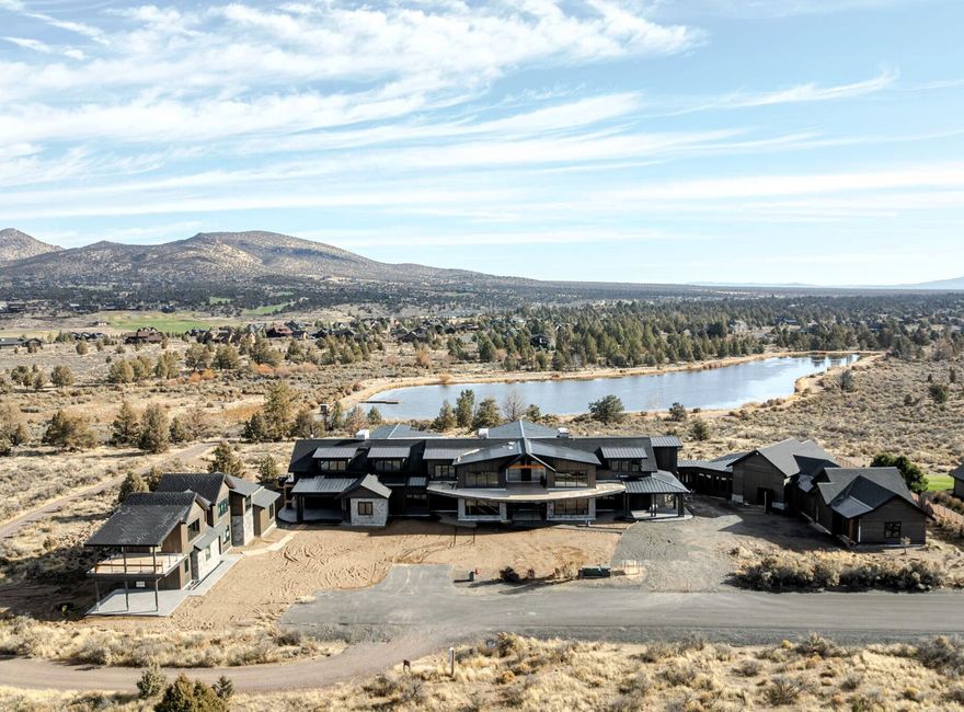 Among Central Oregon's most compelling estates, this Brasada Ranch masterpiece sits atop a private community lake with sweeping Cascade views and BLM land next door for rare privacy. Designed at an exceptional scale for gathering and retreat, it blends expansive indoor-outdoor living, multiple ensuite retreats, and a separate casita with the backdrop of one of the region's premier resort communities. The opportunity: finish the residence your way—continue with the approved plans and professional interior design already in place, or chart your own course and personalize every detail. Then shape the finishing touches to reflect how you live—welcoming big gatherings, quiet mornings, and everything in between. Also enjoy Brasada Ranch's amenity-rich lifestyle—golf, dining, pools, fitness, horseback riding, and miles of high-desert adventure—making this a rare offering for those seeking beauty, privacy, and possibility in equal measure.