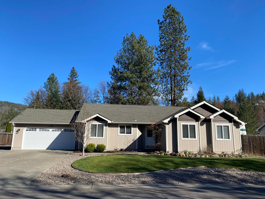 Bright and spacious 3 bedroom 2 bath home in the small town of Shady Cove. The front yard is nicely landscaped and open to the street with a gorgeous magnolia tree that blooms every spring, and provides shade in the summer. The backyard is fully fenced and has large maple trees as well a a deck running the length of the home which is great for those summer barbecues or just enjoying the peace and quiet. Both the front and backyard have in-ground sprinkler systems and yearly irrigation from the Rogue River. Large RV parking runs the depth of the lot and allows for lots of room to add a shed for additional storage. Newly finished 2 car garage, new flooring in laundry room as well as new carpeting and paint throughout. Come see it, you'll want to move in!