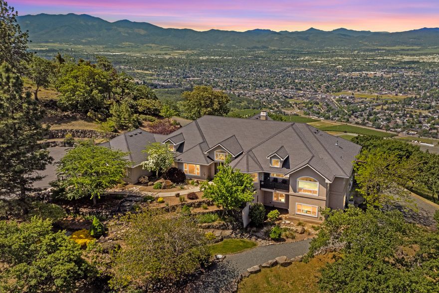 Step into unparalleled beauty and comfort, set on 11 acres of pristine land. Life slows down. The views from every window remind you to savor the moment, whether hosting or enjoying a quiet evening. The heart of the home, a chef's kitchen, opens to a spacious great room and expansive deck with covered patio; the ideal setting for al fresco dining. At the end of the day, retreat to the primary suite, where luxury awaits. View Table Rock as you enjoy the two-sided gas fireplace, soaking tub and heated floors. 3830 sq ft of main level living area. The lower level offers another 2523 sq ft, and endless possibilities with bonus rooms, a full bath, and additional entrances. A detached, remodeled ADU adds 768 square feet of versatile space, complete with a bathroom, perfect for guests. At the end of a gated road, bordering BLM, this private estate includes a 3-car garage and greenhouse. City water, natural gas, and fiber optic, ensure convenience on this stunning retreat.