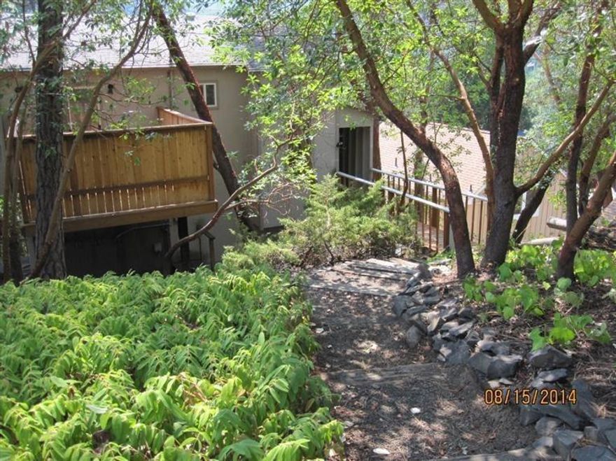 Your own private getaway, a perfect 2nd home or a great place to raise your family in a small town atmosphere. It's just a few blocks from downtown and the Rogue River. It is only a short drive to Medford or Grants Pass. This home offers new carpet, new paint, new vinyl. The kitchen has new granite counter-tops, new sink and new range/oven. Master suite is on the main floor with a private deck. Lower level offers 2 bedrooms with an updated full bath and a laundry room/over-sized with room for an office or craft room. Garden area with 9 raised beds is nestled at the bottom of the property.Gold Hill offers biking, fishing, zip line, golf & more in areas nearby. Live in a tree house, come and look.