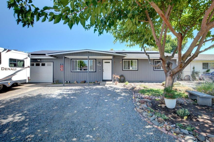 Beautiful home with many upgrades!  New laminate floors throughout, insulated garage and newly created utility clean room, new outbuilding, new paint inside and out within the last year, new front patio cover, a new roof with solar panels a few years old at a cost of $36,620, and extensive, stunning brand new front landscape, manual drip irrigation system and a small dog kennel.  There is a huge amount of extra off street parking.  Several other upgrades were done a few years ago, including vinyl windows!  Easy to show.  This one won't last.