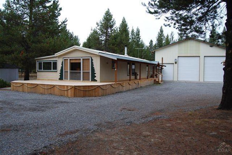 Seller turned this mfg. home into a cute vacation cabin has lots of Pine accents. 2 bedroom, 1.5 bath on 1 acre of land. Brand new deck wraps 1/2 way around the home. Full RV hookup for extra guest. 1600 SF Shop with power and cement floor. 1 storage sheds, completely fenced and gated. 21st Mortgage Corp. said they can finance singlewide mfg. homes. Ask your agent for more information.