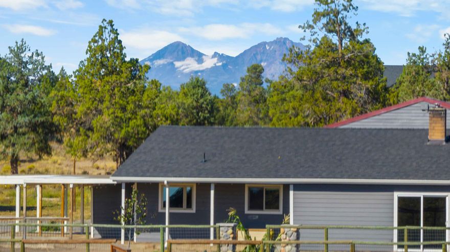 Beautiful 5-acre property in desirable Tumalo with perimeter and cross fencing, level terrain, mature trees, and sweeping pasture views. An ideal setting for hobby farming, equestrian pursuits, or simply escaping to your own peaceful retreat. The well-maintained residence provides peace of mind with recent upgrades including a new roof, furnace, A/C, and water heater. Outdoor enthusiasts will appreciate direct access to BLM land and the Maston Trailhead just across the street, perfect for hiking, biking, and horseback riding. A versatile 2,400 sq. ft. shop, built in 2005, features concrete floors, 220 power, RV hookup and dump, plus a private upstairs office, making it ideal for a variety of uses. The acreage offers ample room for equestrian facilities, gardening, or enjoying the wide-open skies of Central Oregon. Conveniently located just minutes from Tumalo's local shops, dining, and the Deschutes River, this property perfectly blends rural charm in a sought after area of Tumalo.