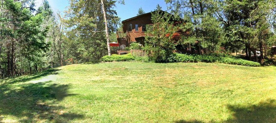 Peacefully nestled in a beautiful 3.48 acre end-of-the-road setting. 1934sf main home PLUS 510sf detached guest studio. Light-filled home boasts soaring cathedral ceilings & vast energy efficient top grade windows that open out to serene views in every direction. Open floor plan, new #1 maple flooring. Spacious well cared for open cedar decks, updated bright kitchen with S/S, granite & calming views. Large loft area could be 3rd BR. Huge Master BR w/gorgeous wooded views. Large laundry room w/cabinets & sink. 30'x30' insulated, heated & finished dream garage. Modern light-filled 17'x30' guest studio w/private deck & entrance sits above the garage; includes full bath, efficiency kitchen w/ new fridge, A/C, heat, & private laundry. Natural landscaping, lovely pond, fenced garden area. You must see the list of amenities, all recent improvements made with an eye towards energy efficiency and design. Great neighborhood and very accessible10 min to downtown's G St. and 7 min to Merlin.