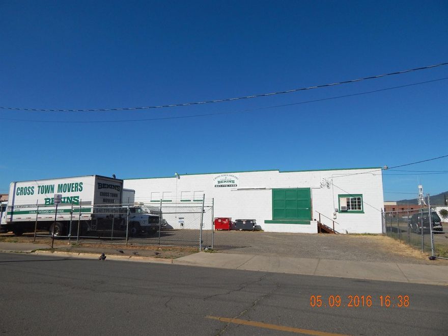 Excellent downtown location. Consisting of two separate units, this 9,600 square foot warehouse space has high ceilings and a dock level bay door. There are several storage rooms and an office in the building, as well. Large corner lot with fenced parking area. Listing agent is related to Selling company's manager. All information deemed reliable but not verified or guaranteed; anyone considering this property should perform their own investigation into the uses and condition of the property.