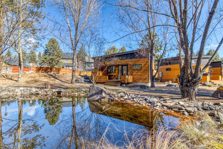 Welcome to your park-like surroundings and adorable home located in the cottage community of Hiatus with a HES of 10!! Unit 8 is situated perfectly facing the community private ponds and just a few steps to your designated parking. Hiatus features pathways, ponds, gardens, and firepits for your use and to extend your living area, all maintained by the HOA. Inside you'll find natural light, beautiful colors and creative solutions for simple living.  Wood flooring, tile showers, marble countertops, and built ins add to the appeal of this well constructed home.  Schedule your showing today.