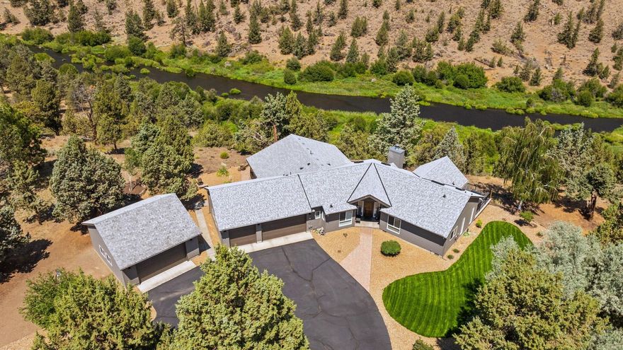 Perched on the rim above the mighty Deschutes, this stunning home is situated on 3.5 acres of rare riverfront property w/access just off the deck. Gated community w/ unobstructed views across the canyon w/wildlife right out your door. No detail missed w/top to bottom renovations in past 2 years. Contemporary wood finishes & ftrs elevate the living spaces. Vaulted great room w/floor to ceiling windows & skylights. Cozy wood burning FP w/stone surround, custom hearth & mantle. Chef's style kitchen ftrs Quartz countertops, range w/hood, massive island w/bar seating, built-ins & lg pantry. Serene Primary Suite overlooking the river, sliding doors to a deck w/hot tub, lg bath w/glass enclosed tile shower, dual sinks! 2 addtn'l bedrooms share a private bath. Flex room/4th br accessed thru the laundry/mud rm, office off entry, covered sitting area on massive deck. Immaculate landscape, triple attached garage, heated/cooled detached dbl garage, 30x60 pull through RV garage/shop & more!