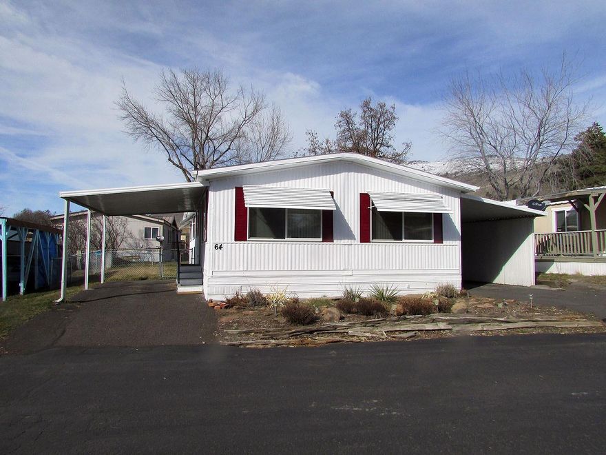 Two large Bedrooms with 1 &1/2 bathrooms, very roomy 1296 Sq. Ft. Manufactured Home. 112 sq. ft carpeted, covered deck that could easily be enclosed for additional living area. Plenty of parking with paved driveways and covered carports on either side. Completely fenced back yard and a roomy storage building.