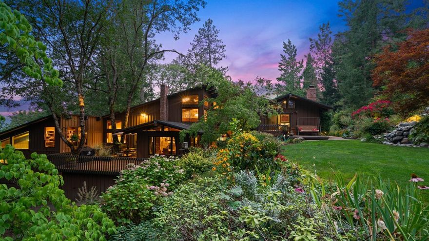 This is the quintessential rural property dream for the discerning outdoorsman. Situated on 169.83 acres, this private estate includes over 10 miles of riding trails, access to 3,000 (+/-) acres of public lands, great hunting, hiking & more! The grand, lodge style residence boasts over 7600 square feet & is accented with quality woodwork & soaring ceilings throughout. Surrounding the home is breathtaking mature landscaping, multiple deck & patio areas, a cascading water feature with small pond, & an in-ground pool with expansive patio. A true Northwestern setting with a variety of native trees, plants & two creeks. Improvements include a lighted tennis court, horse barn, shop with RV parking, paved driveway & a whole house backup generator system. Multiple tax lots provides potential for additional homesites. Peaceful & privately set in the beautiful Rogue Valley, you will forget that you're only minutes to town as well as the renowned Rogue River. High speed cable internet available