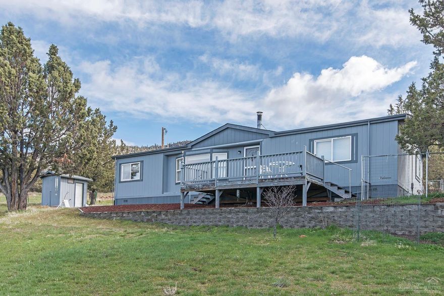 49 parklike fenced acres, limbed Juniper trees, panoramic Cascade & valley views. Home is an Alaska Pack Ardmore home that will stand the coldest of weather. Private well pumps up hill to 2-1800 cisterns, allowing domestic water to come by gravity feed to home. The pond is spring fed & designated as a wildlife pond. Heat is provided by a newer quiet Coleman furnace & a Lopi woodstove. Property inc handcrafted log barn, storage building & covered carport. Property is private, yet close to Madras & Prineville