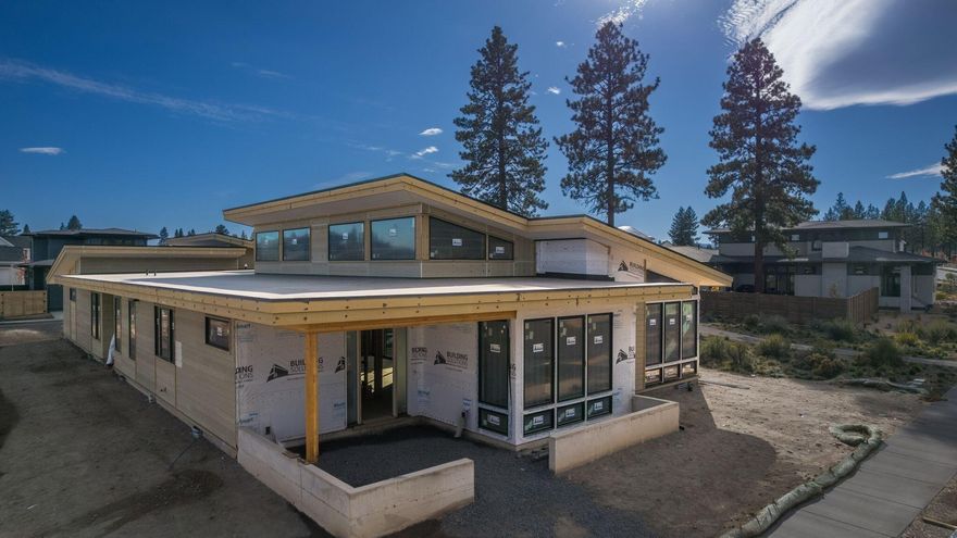 Brand New Quality Construction in the latest phase of popular Discovery West in NW Bend. Walk or bike out your door to trails, shops, restaurants, schools and parks. This mid century modern, single level home sits on a .21/acre lot, next to the community path, giving it extra space between the homes. The 2564 SF lives large with vaulted ceilings and beautiful windows throughout. The kitchen is a focal point with Jenn Air appliances, including a 36 inch gas cooktop, a large 8 foot wide island and custom cabinetry. More special features include a courtyard enclosed by three sides of the home within the fully fenced and landscaped yard. The garage is accessed from the alley behind the home. The third bay is 11 ft tall, perfect for sprinter/adventure vans. This builder is known for being ''hands on'',  overseeing every detail of the home, he is available to buyers not just during the sale process, but in the years to come. This is an ideal home and neighborhood for the Bend lifestyle.