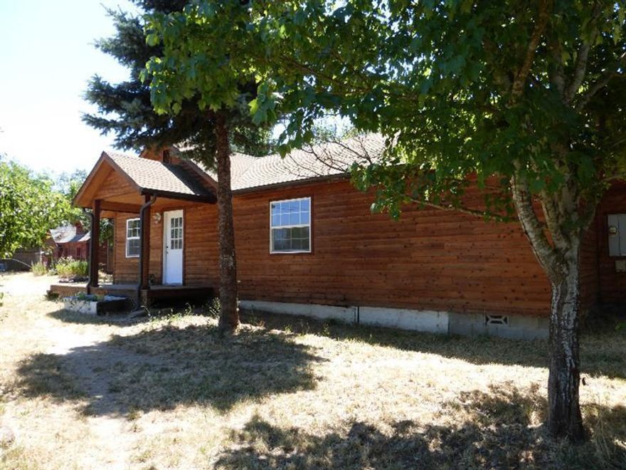 Charming country home located back off the main road. One can find just about everything on this 5 acre property. 3 bedroom 21/2 bath Cedar sided home,open kitchen family room with a long counter area.The master bedroom has it's own rock fireplace with a jet tub in the bathroom,and a Bay Window.For your dogs there is dog washing area in the laundry room. Numerous out buildings for critters or what ever. Enjoy your pond that is fed by irrigation water with a year around creek that runs through it. Bring on the horses!! Enjoy the 90x50 Covered Arena. Also a small barn in the upper pasture with a round pen for more training. This home was originally built in 1947 but was completely remodeled in 1999, with permits. Now it has new carpet and painted inside and out. Ready to move in.